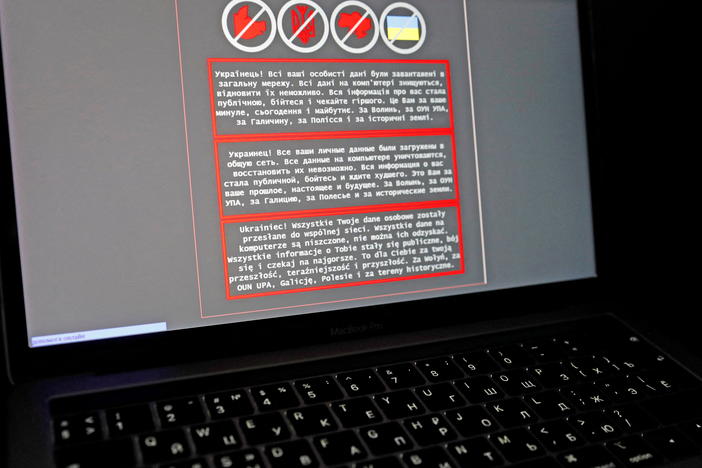 A laptop screen displays a warning message in Ukrainian, Russian and Polish that appeared on the official website of the Ministry of Foreign Affairs of Ukraine after a massive cyberattack on Friday.