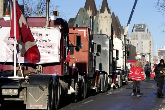 A person wears a Team Canada hockey jersey after city officials negotiated to move some trucks towards Parliament and away from downtown residences on the 18th day of a protest against COVID-19 measures that has grown into a broader antigovernment protest in Ottawa on Monday.