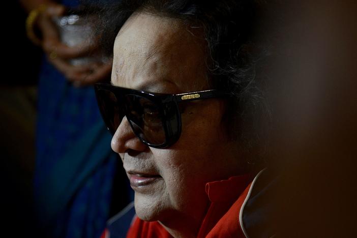 Bollywood singer and music composer Bappi Lahiri speaks to the media before planting a tree during an environmental awareness campaign in Mumbai on June 19, 2021.