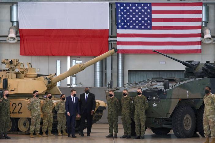 Secretary of Defense Lloyd Austin and Polish Defense Minister Mariusz Blaszczak stand with Polish and U.S. soldiers at the 33rd Air Base of the Polish Air Force near Powidz during a visit last week.