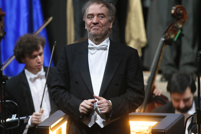 The management company of conductor Valery Gergiev has decided to drop him over his close ties with Russian President Vladimir Putin.