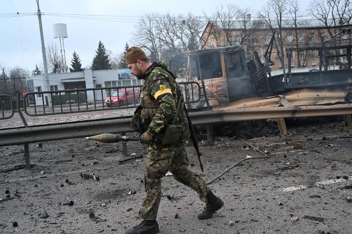 Ukrainian service members collect unexploded shells after fighting with Russian forces in the Ukrainian capital of Kyiv in the morning of Feb. 26, 2022, according to Ukrainian service personnel at the scene.