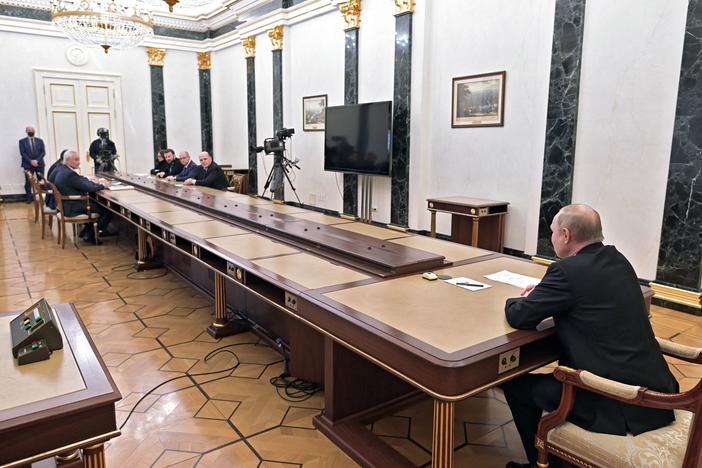Russian President Vladimir Putin chairs a meeting on economic issues at the Kremlin on Monday as the ruble fell and Russia's central bank raised its key interest rate to a historic high.