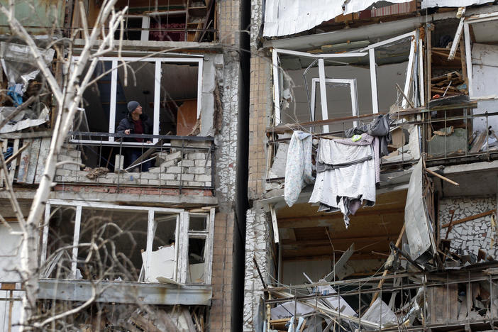 A resident looks out of the destroyed front of a room in a multi-storey building that was badly damaged as a result of Russian missile explosion after it was shot down over the city by Ukrainian air defence on March 6, in Kramatorsk on March 7.