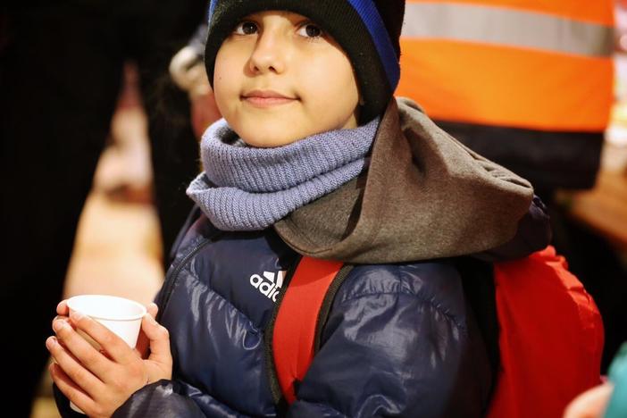 A Ukrainian boy named Hassan, 11, smiles after being welcomed across the border in Slovakia.