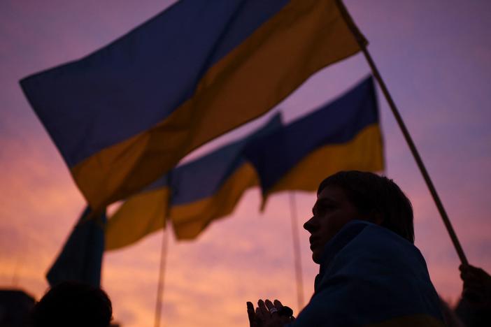 A demonstrator, holding a Ukrainian flag, participates in a demonstration called by 70 associations in support of Ukraine on the square of Paris' town hall on Thursday. It has been three weeks since Russia began its assault on Ukraine.