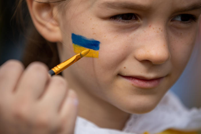 <strong>March 20:</strong> Rachel Nockles, 7, gets a Ukrainian flag painted on her face at a STANDwithUKRAINE rally in front of the White House. Her mother is from Ukraine, but her family now lives in Bethesda, Maryland.