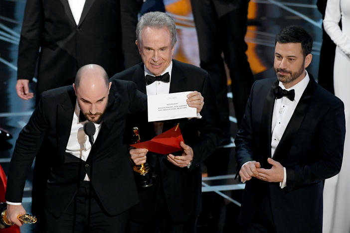 <em>La La Land</em> producer Jordan Horowitz holds up the winner card reading actual Best Picture winner <em>Moonlight</em> with actor Warren Beatty and host Jimmy Kimmel onstage during the Academy Awards in 2017.