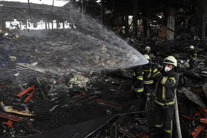 Firefighters continue working on Tuesday to cool down a destroyed logistics warehouse where thousands of tons of food became unusable after Russian shelling hit the facility on March 13 in Kyiv, Ukraine.