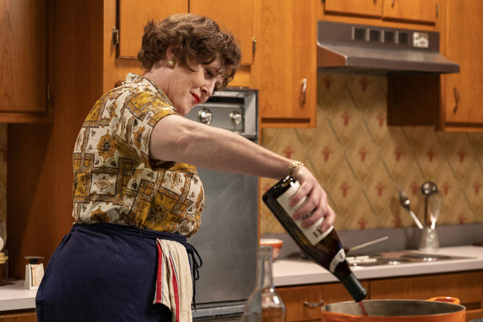 Sarah Lancashire as Julia Child pours a bottle of wine in episode 2 of the new HBO Max series, "Julia."