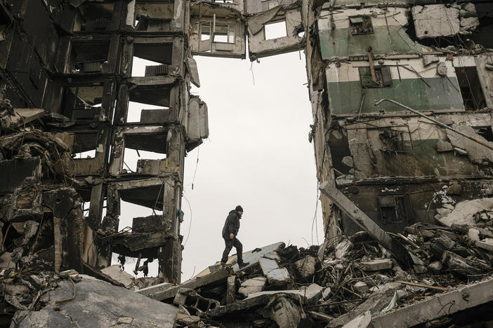 A resident looks for belongings on Tuesday in an apartment building destroyed during fighting between Ukrainian and Russian forces in Borodyanka, Ukraine.