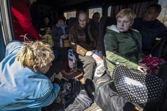 People crowd into a bus on Thursday on their way to a train station in Severodonetsk, as they try to flee eastern Ukraine.