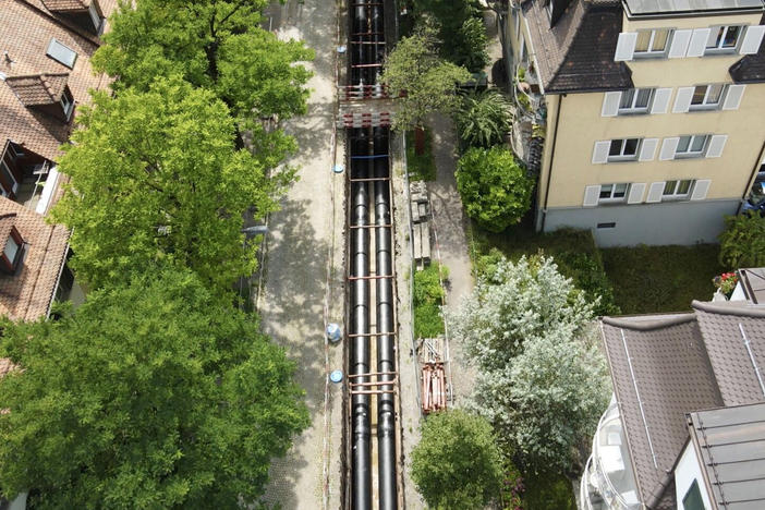 Zurich is expanding its district heating system, which delivers hot water and steam through underground pipes. With more buildings relying on this system for heat, there's less demand for natural gas.