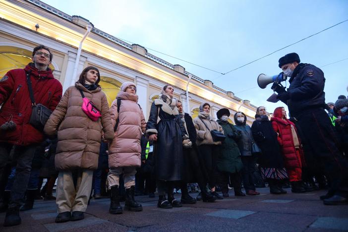 A police officer uses a loudspeaker to address people gathered in St. Petersburg to protest Russia's invasion of Ukraine on Feb. 24.