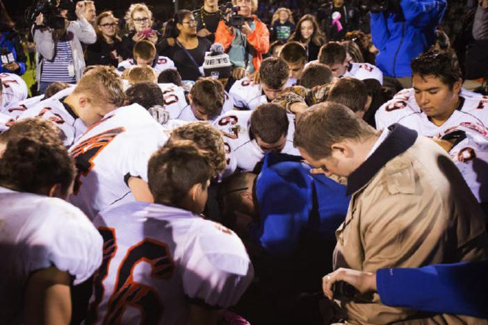 The parties included this image of Coach Kennedy, praying with the crowd after the homecoming game, in their joint appendix submitted to the Supreme Court.