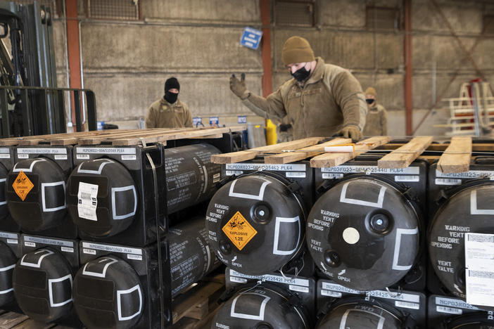 Airmen and civilians from the 436th Aerial Port Squadron place ammunition, weapons and other equipment on pallets bound for Ukraine at Dover Air Force Base in Delaware on Jan. 21, 2022.