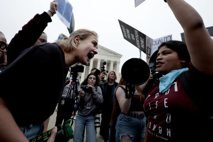 Abortion rights and anti-abortion activists demonstrate in front of the Supreme Court on Tuesday.