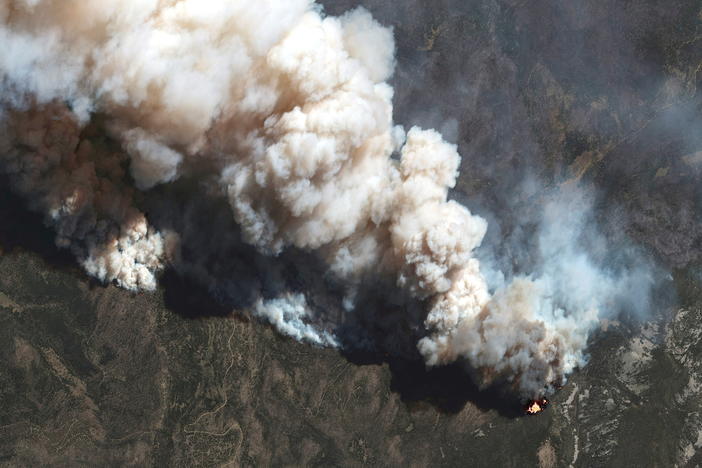 A satellite image shows a natural color view of active fire lines from the Hermits Peak and Calf Canyon fires, near Las Vegas, New Mexico, on May 11.