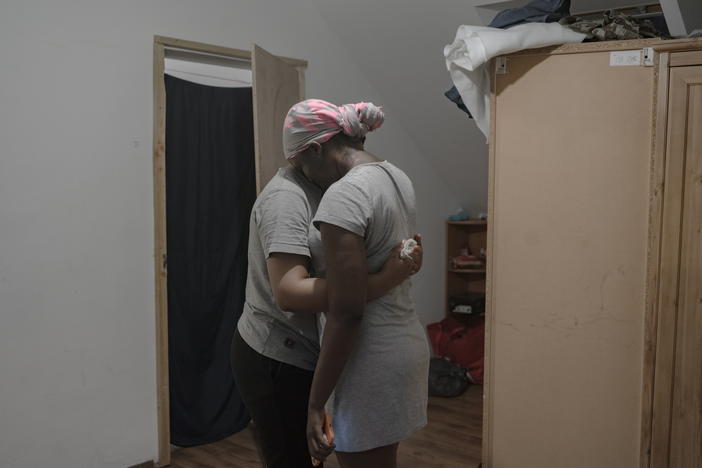 Ima hugs Shakira at a shelter provided by the Nigerians Diaspora Organization in Poland.