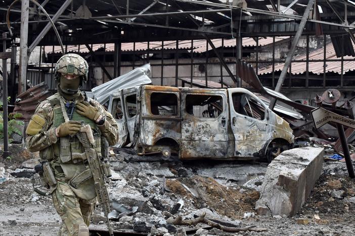 A Russian serviceman patrols the destroyed part of the Ilyich Iron and Steel Works in Ukraine's port city of Mariupol on Wednesday.