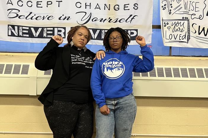 Rev. Denise O. Walden-Glenn and Alia Williams each raise a fist— a symbol of solidarity and Black power— at the VOICE office in Buffalo, New York.