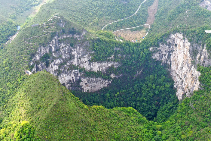 An aerial photo taken in April 2020 shows the scenery of a giant karst sinkhole in China's Guangxi Zhuang Autonomous Region. A similar sinkhole was found earlier this month with an ancient forest at the bottom with trees towering over 100 feet tall.