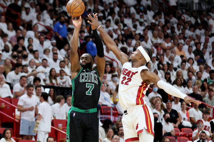 Jaylen Brown of the Boston Celtics shoots the ball against Jimmy Butler of the Miami Heat during the fourth quarter in Game Five of the 2022 NBA Playoffs Eastern Conference Finals at FTX Arena on May 25, 2022 in Miami.