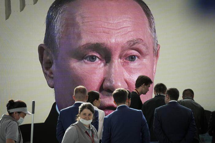 Participants watch Russian President Vladimir Putin address the St. Petersburg International Economic Forum in St. Petersburg, Russia, on Friday.