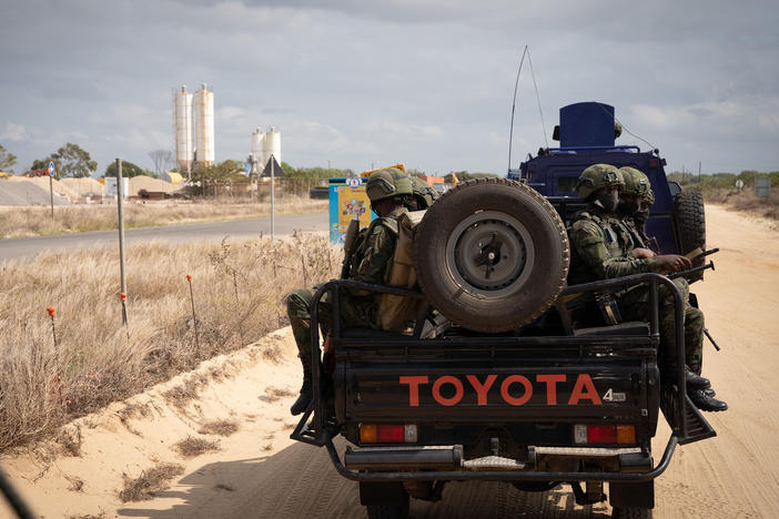 Soldiers patrol near the TotalEnergies complex in Cabo Delgado, Mozambique. Last year the insurgency caused TotalEnergies to put onshore operations on hold. But Italy's ENI and ExxonMobil are moving ahead with a new floating LNG ship offshore. It plans to deliver its first LNG later this year.