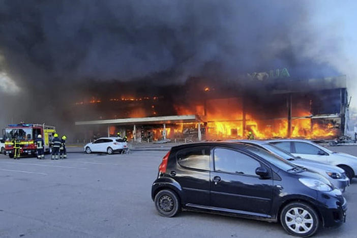 In this image made from video provided by Ukrainian State Emergency Service, firefighters work to extinguish a fire at a shopping center burned after a rocket attack in Kremenchuk, Ukraine, on Monday.