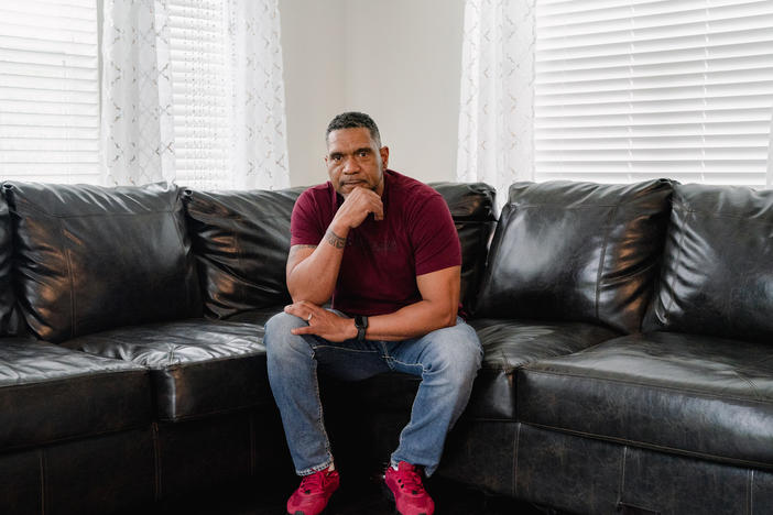 Tyrone Ferrens, a plant electrician at Under Armour, sits for a portrait in his house in Aberdeen, Md.
