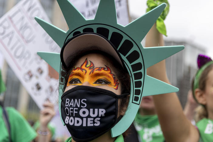 Sonia Glenn from Fairfax, Virginia in a Statue of Liberty costume at the rally in Lafayette Square park before the Women's March in Washington, D.C to protest the Supreme Court's overturning of Roe V. Wade.