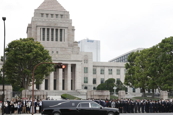 A hearse which carries the body of former Prime Minister Shinzo Abe, makes a brief visit to the House of Parliament after his funeral Tuesday, July 12, 2022, in Tokyo.