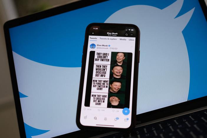 Elon Musk's tweets mocking Twitter's lawsuit are displayed on a smartphone with Twitter logo in the background in this illustration photo taken on July 18, 2022.