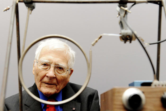 Scientist and inventor James Lovelock poses with one of his early inventions, a homemade gas chromatography device, used for measuring gas and molecules present in the atmosphere, at a science museum in London.