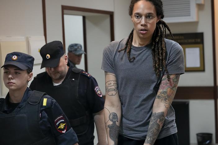 WNBA star and two-time Olympic gold medalist Brittney Griner is escorted from a court room ater a hearing, in Khimki just outside Moscow, Russia, Thursday, Aug. 4, 2022.