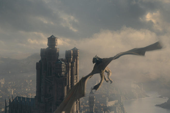 Red Keepin' it 100: A dragon flies over King's Landing on <em>House of the Dragon</em>.