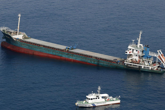 This aerial photo shows Belize-registered cargo ship Xin Hai 99 after a collision off of Kushimoto, Wakayama prefecture in southwestern Japan on Saturday.