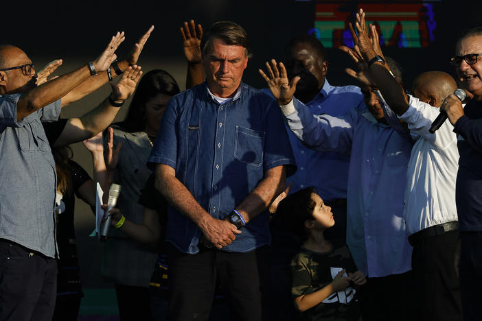 Brazilian President Jair Bolsonaro receives a blessing during a music festival organized by a local evangelic radio station on July 2, in Rio de Janeiro.