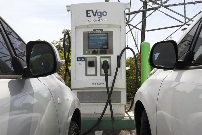 Electric cars are parked at a charging station in Sacramento, Calif.