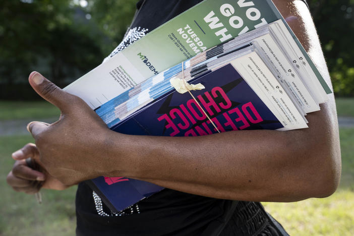 Regina Campbell holds her paperwork for knocking on doors to tell residents about issues on the ballot in the fall, including a potential constitutional amendment on reproductive rights, in Pontiac, Mich., on August 6, 2022.