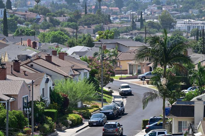 A vehicle drives through a residential neighborhood in Los Angeles.
