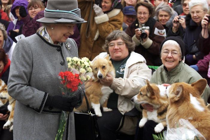 Queen Elizabeth II talks with members of the Manitoba Corgi Association during a visit to Winnipeg, Canada, in October 2002.