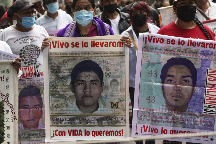 Family members and friends march seeking justice for the missing 43 Ayotzinapa students in Mexico City, Aug. 26, 2022.