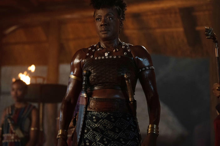 Nanisca (Viola Davis) wields a sword and hacks her way through the many men who get in her way in<em> The Woman King.</em>