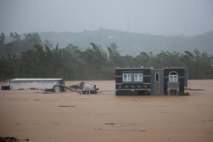 A home is submerged in floodwaters caused by Hurricane Fiona in Cayey, Puerto Rico, on Sunday.