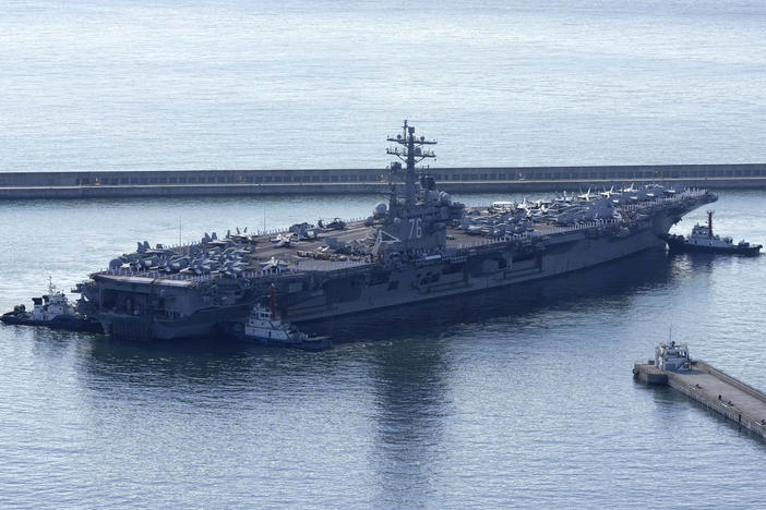 The U.S. carrier USS Ronald Reagan is escorted as it arrives in Busan, South Korea, on Sept. 23. North Korea warned on Saturday that the U.S. redeployment of the carrier near the Korean Peninsula is causing a "considerably huge negative splash" in regional security.
