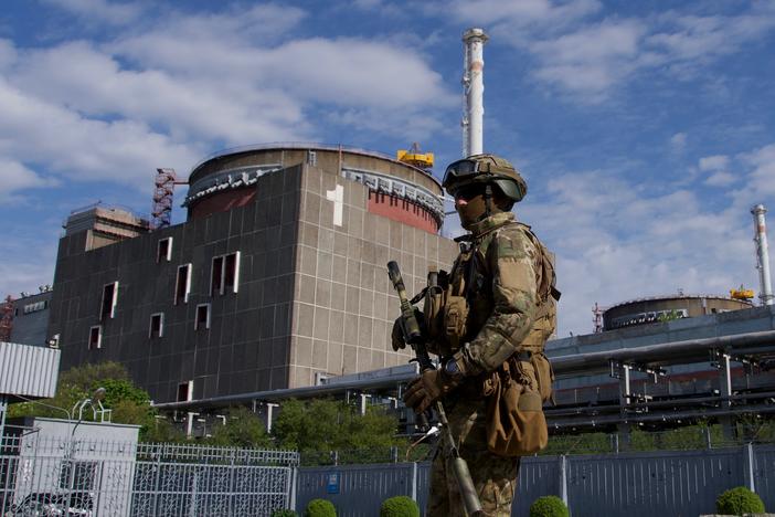 A Russian service member patrols the Zaporizhzhia nuclear power plant in May.