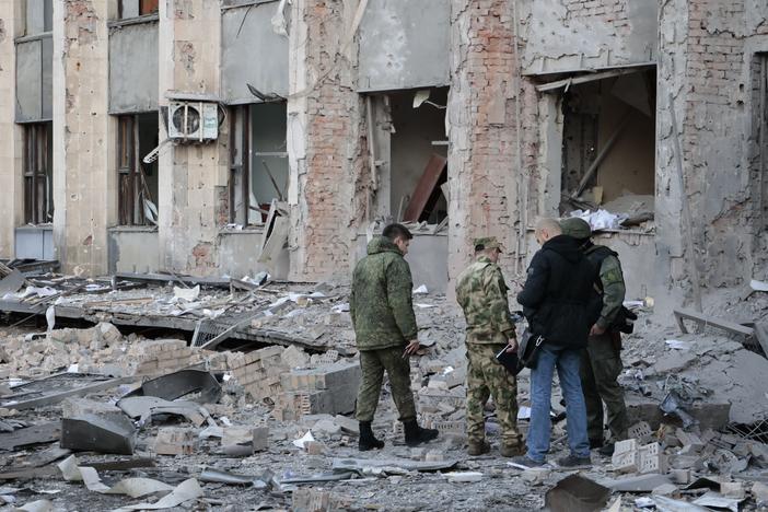 Investigators inspect a site after shelling near an administrative building in Donetsk, the capital of the separatist Donetsk People's Republic in eastern Ukraine, on Sunday.