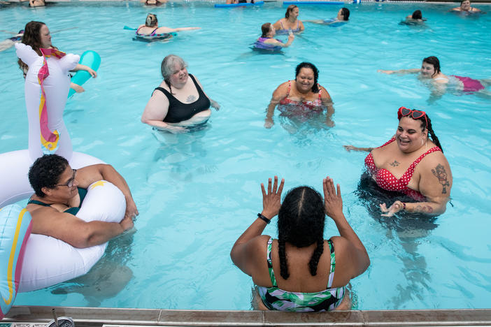Women hang out in the pool and listen to Teri Collins tell them a story at Camp Roundup, a body positivity and acceptance camp for women that took place Labor Day weekend in Newark, Ohio.
